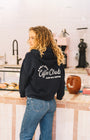 unisex blue navy sweater in a coffee shop