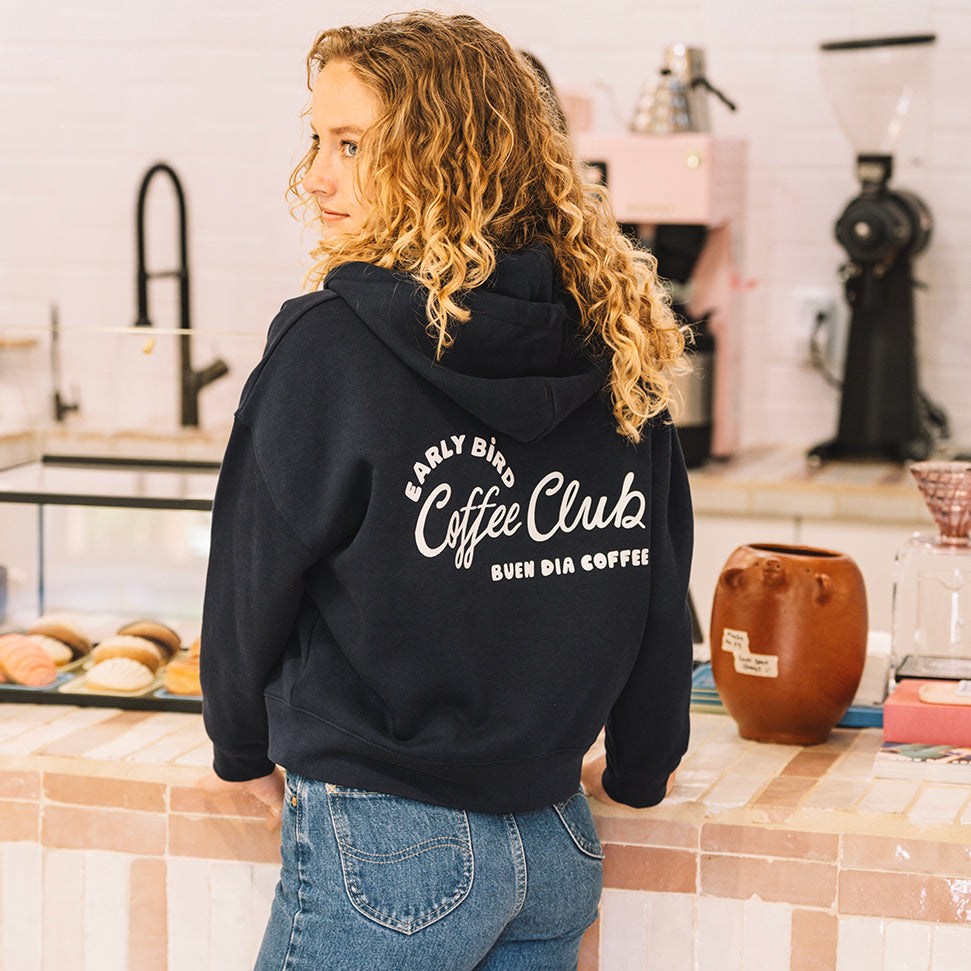 unisex blue navy sweater in a coffee shop