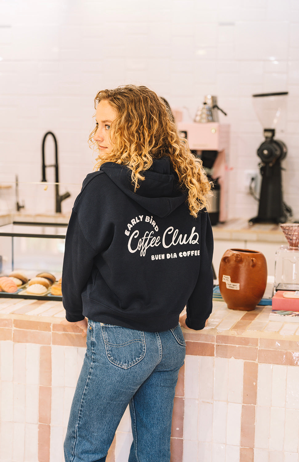 unisex blue navy sweater in a coffee shop