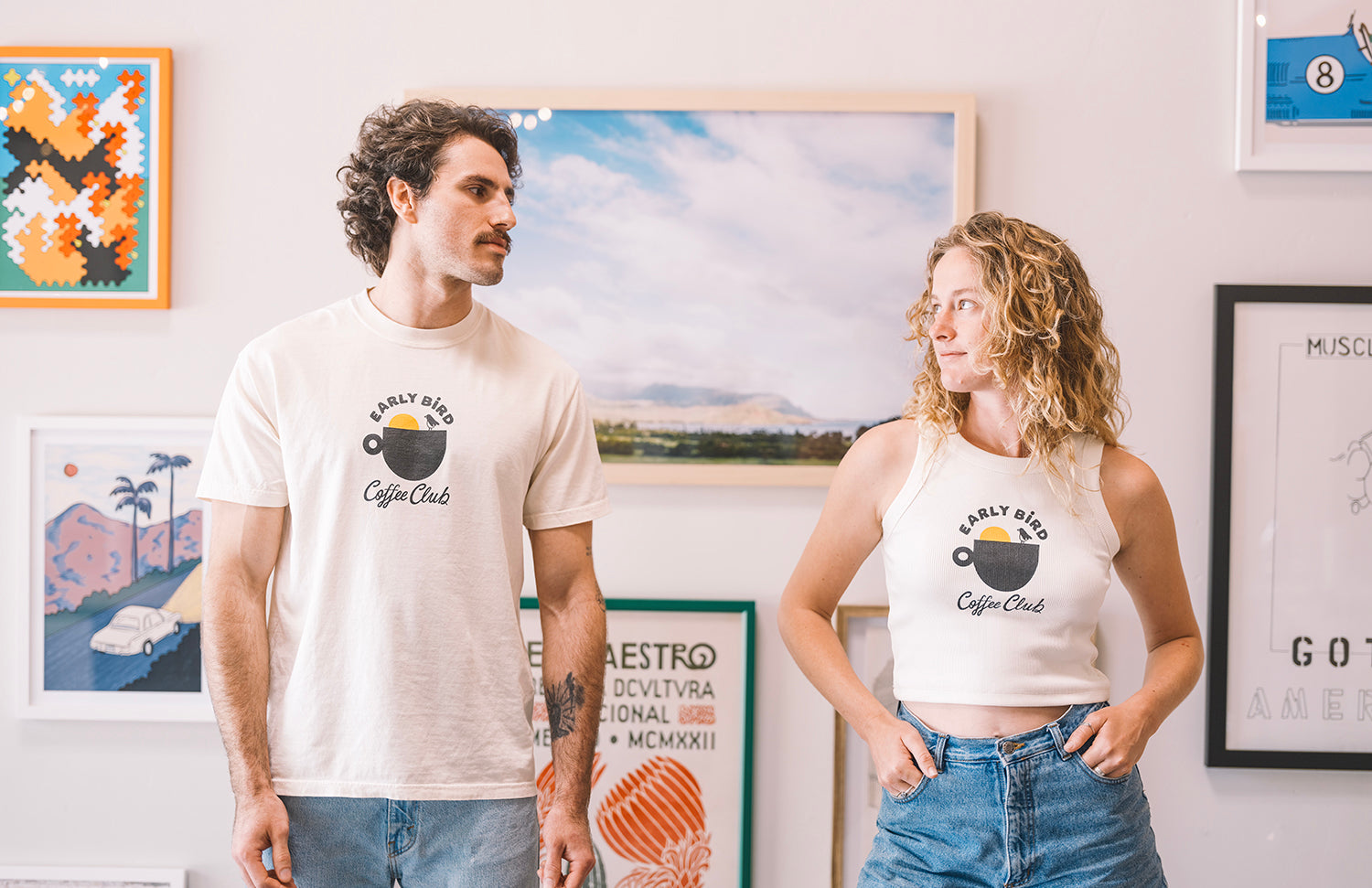 Woman with a Early bird tank top cream and man wearing a cream t shirt in buen dia coffee san luis obispo