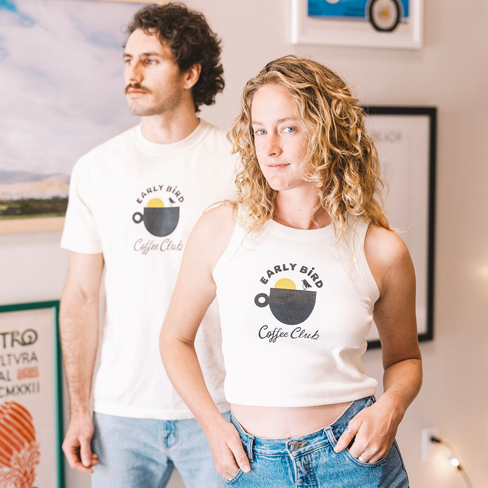 Woman with a Early bird tank top cream and shorts in buen dia coffee san luis obispo