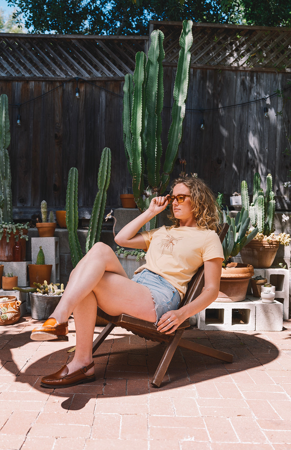 Woman in the sun wearing sunglasses and a yellow t shirt el banano in san luis obispo