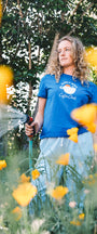 Woman gardening wearing a blue shirt in the sun in san luis obispo
