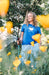 Woman gardening wearing a blue shirt in the sun in san luis obispo